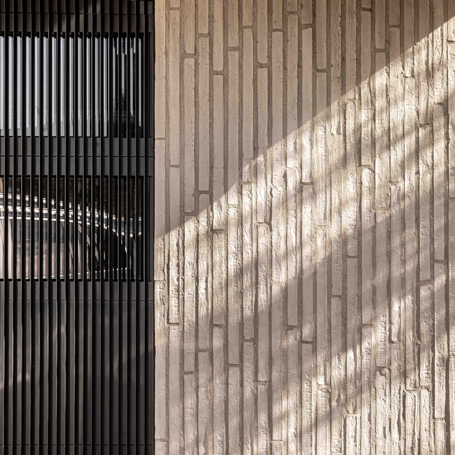Detail study of stonework and black metal fins